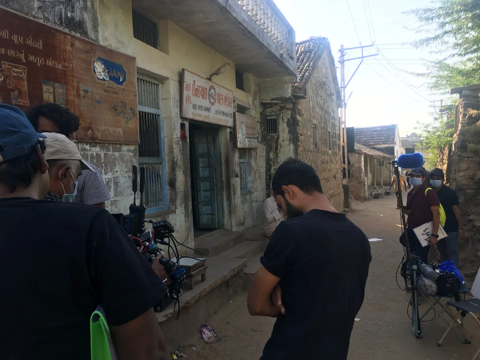 Film crew preparing a location on a village street